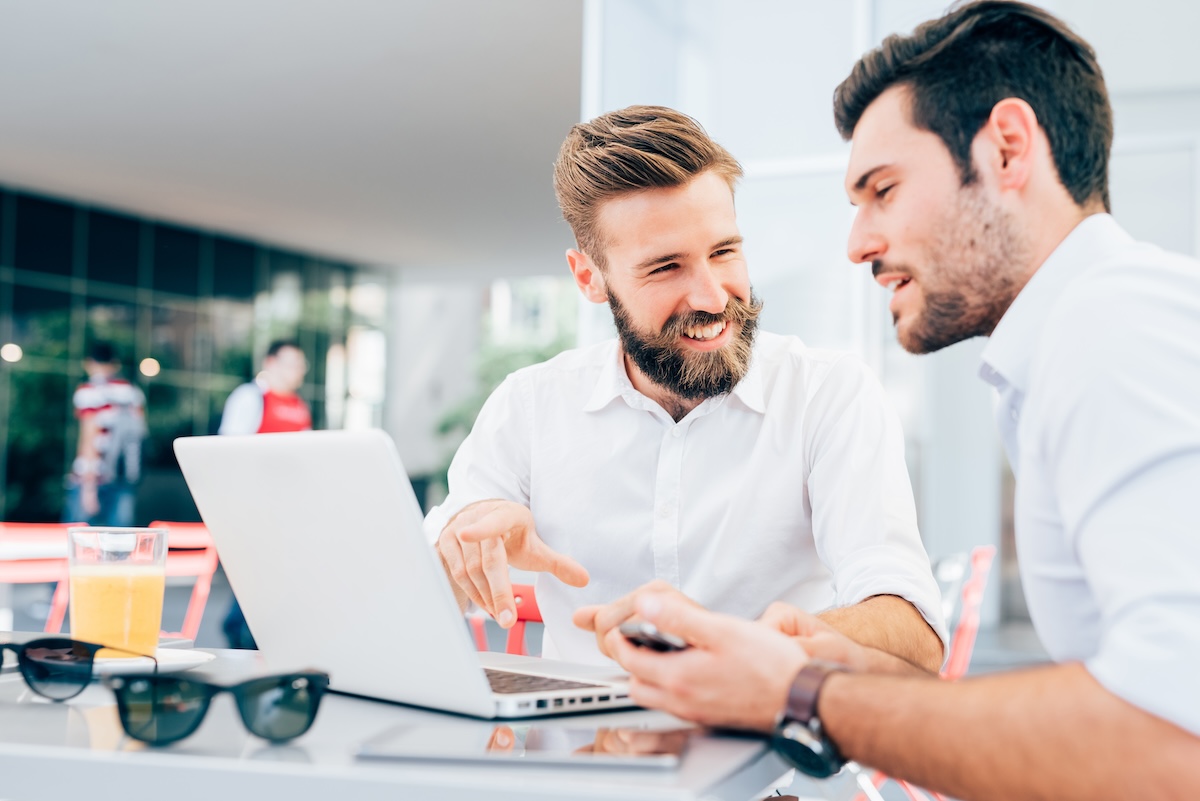 two men using business internet services to collaborate and get work done